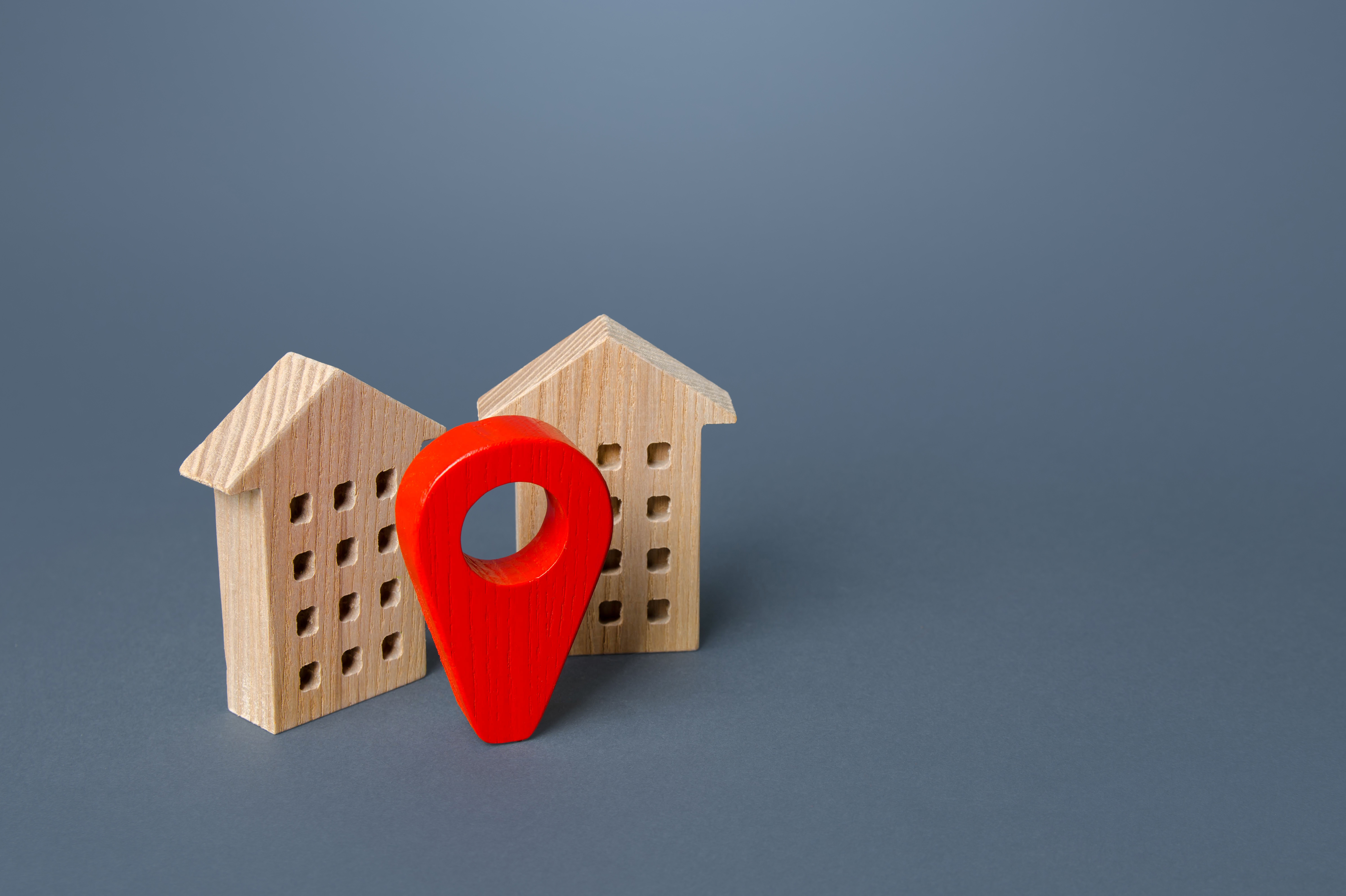 Red location pin and houses. Location concept, settlement. Tracking, internet of things.