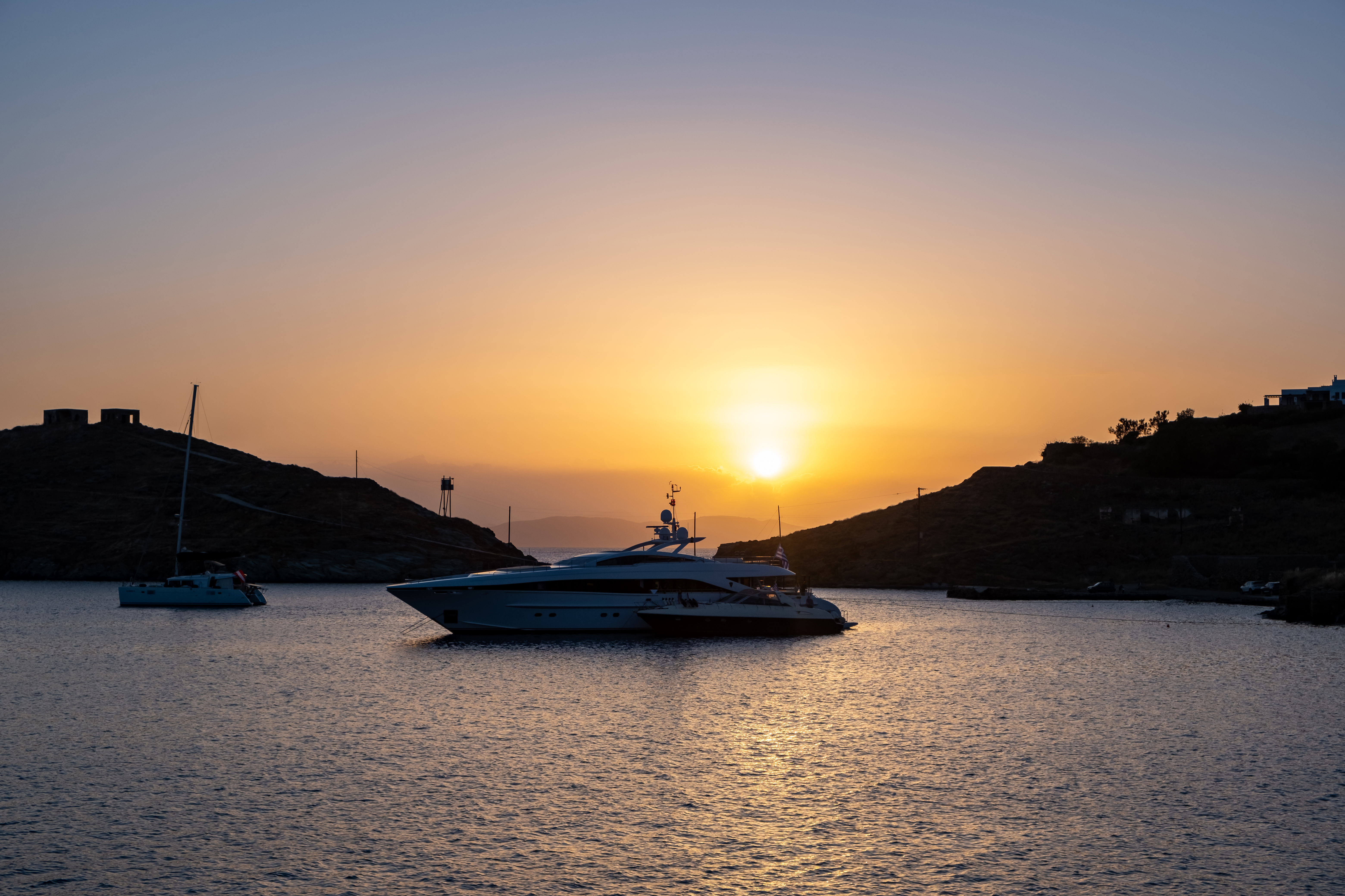 Yacht, luxury boat on calm sea at sunset in the Aegean sea, Greece, Kea island.